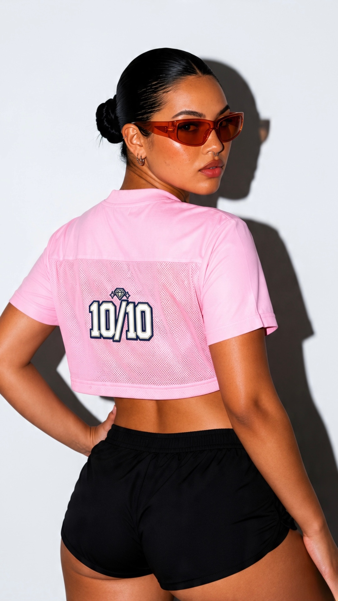 Rose mesh 10/10 jersey crop photographed from behind with black athletic shorts
